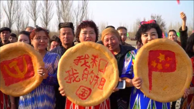 新疆吐魯番迎春慶祝活動期間，「維吾爾人的」「饢」被一些圖案「點綴」，從左到右分別是：中共的黨徽、愛國標語「我和我的祖國」、中國的國旗